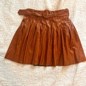 Patent leather pleated belted mini-skirt